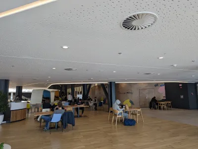 Priestor foodcourtu pod perforovaným akustickým stropom, obchodné centrum Nivy.